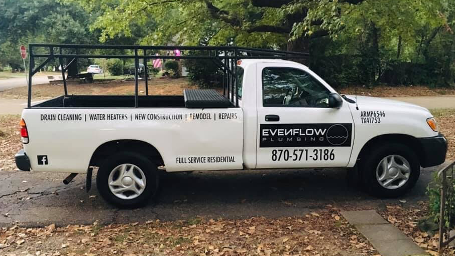 Branded Evenflow Plumbing pickup with ladder rack